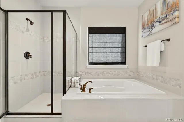 a bathroom with a bathtub and a shower