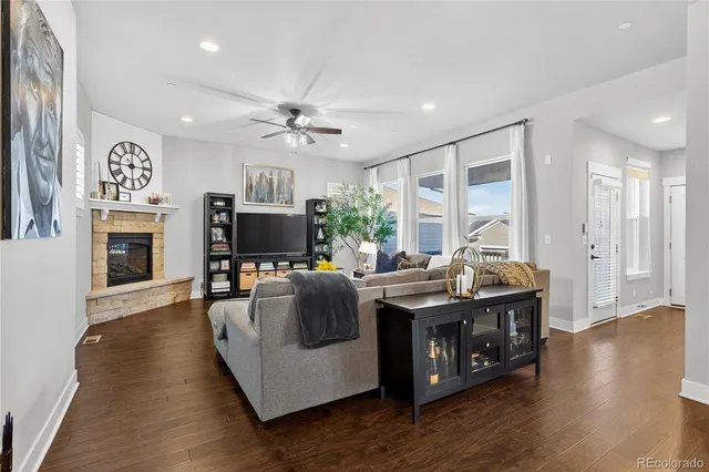 a living room with furniture a fireplace and a flat screen tv