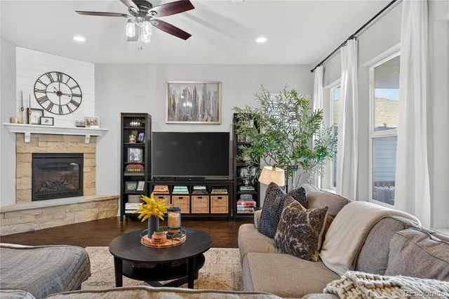 a living room with furniture a chandelier and a fireplace