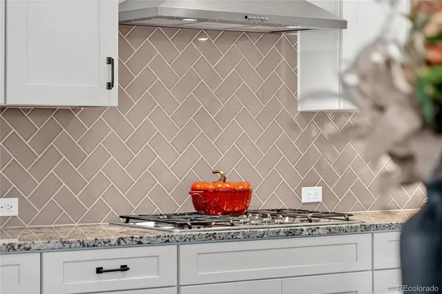 a view of stove with wooden cabinets