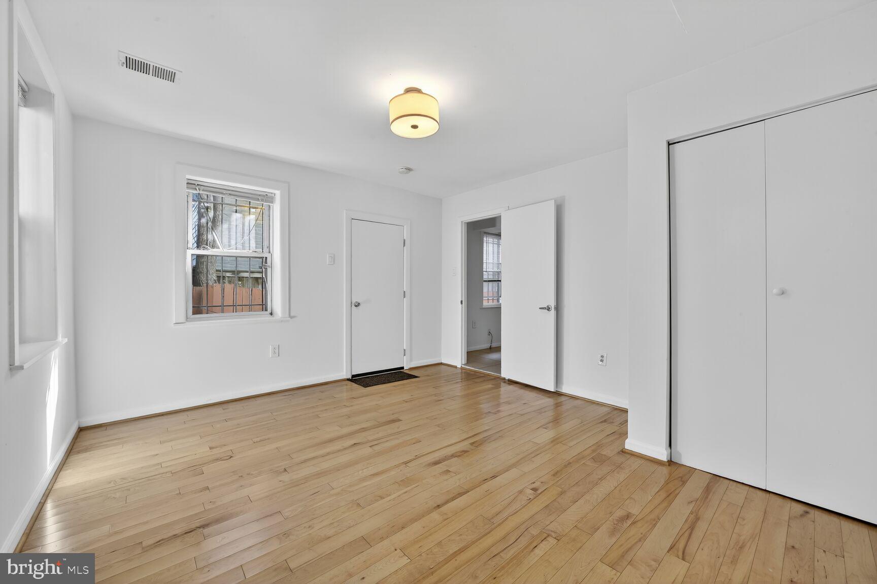 511 P Street Northwest, Unit 2 Washington, DC 20001 - Photo 11 of 15 a view of an empty room with wooden floor and a window