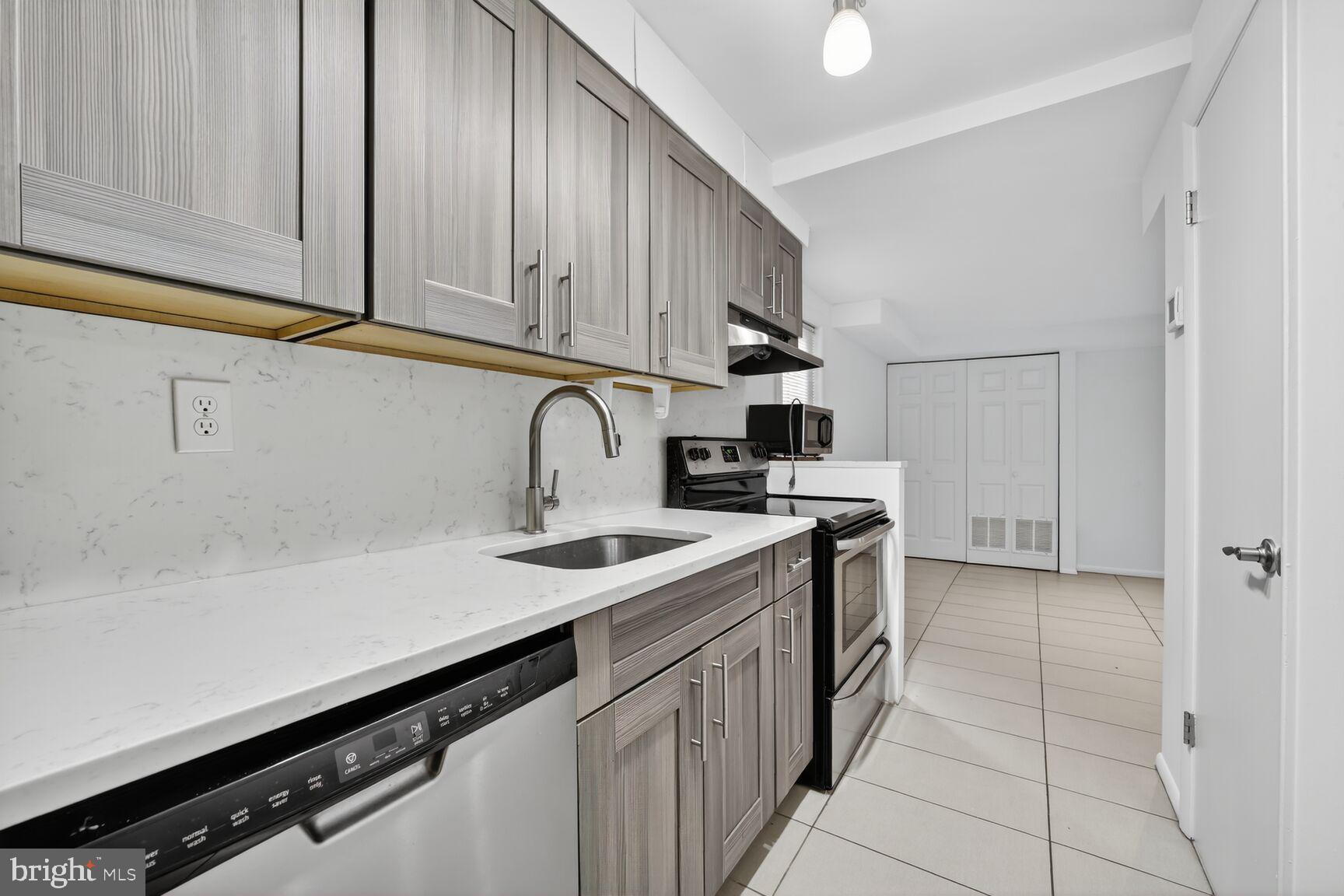 511 P Street Northwest, Unit 2 Washington, DC 20001 - Photo 2 of 15 a kitchen with stainless steel appliances a sink dishwasher stove and cabinets