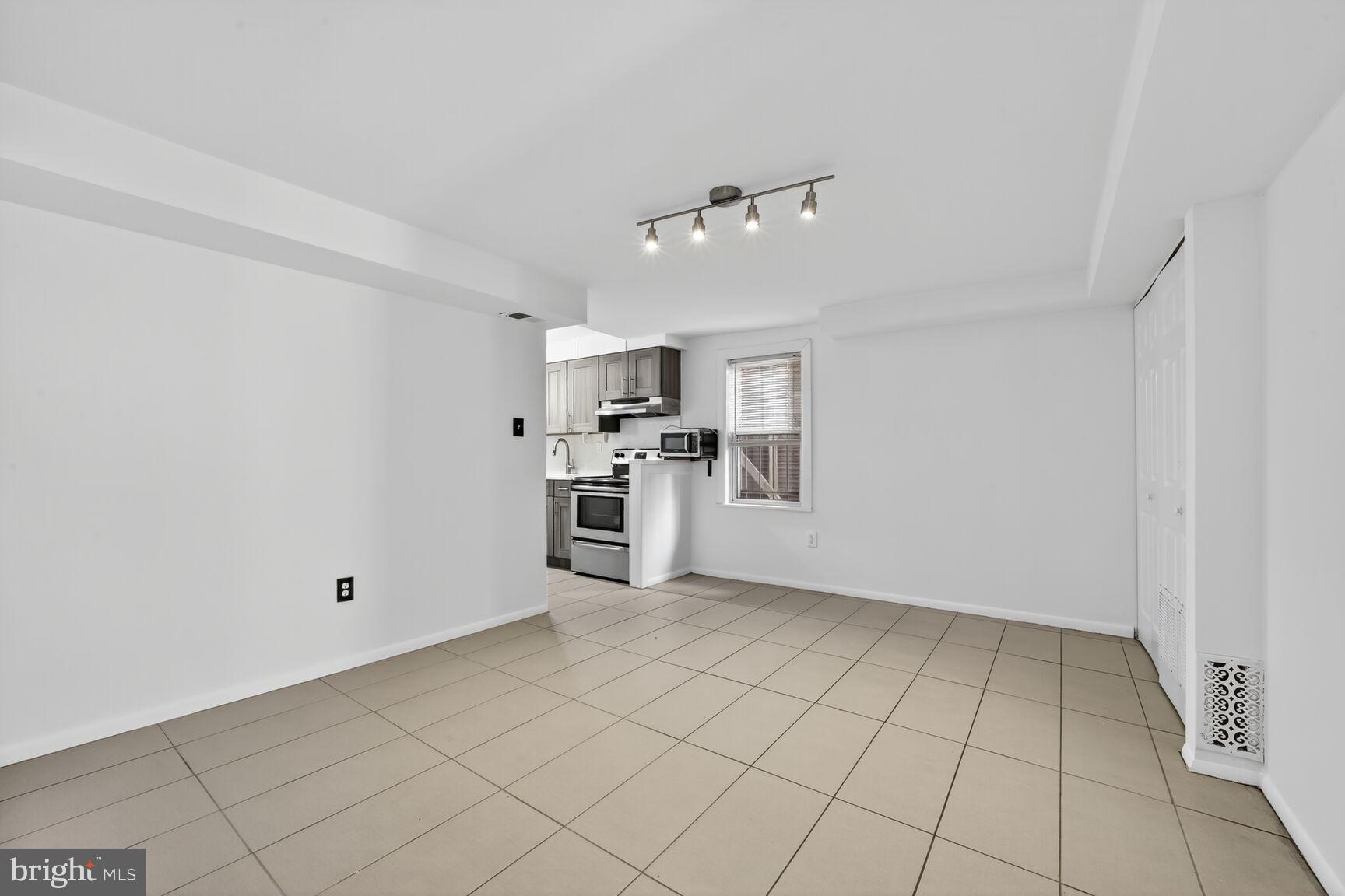 511 P Street Northwest, Unit 2 Washington, DC 20001 - Photo 7 of 15 a view of a kitchen with microwave and white cabinets