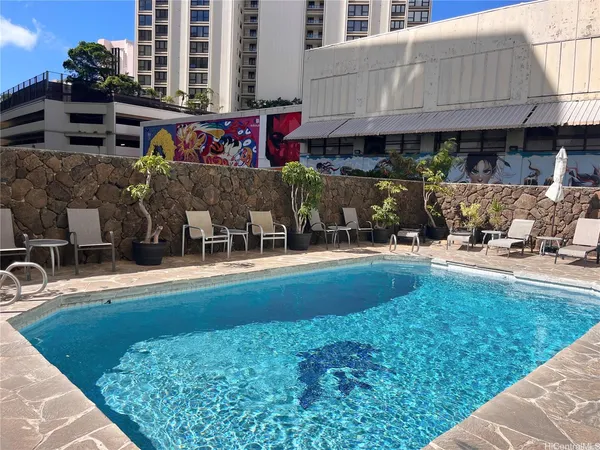 a view of swimming pool with outdoor seating
