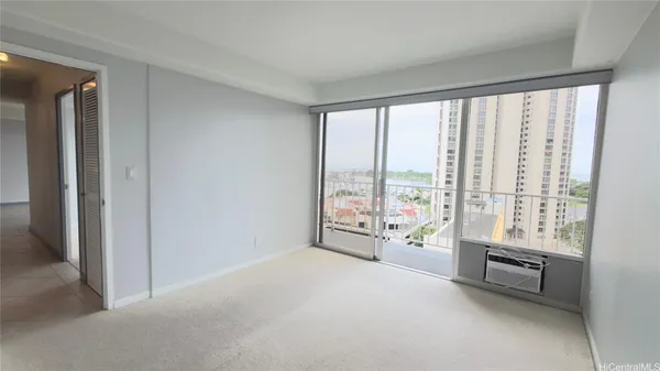 a living room with furniture and floor to ceiling windows