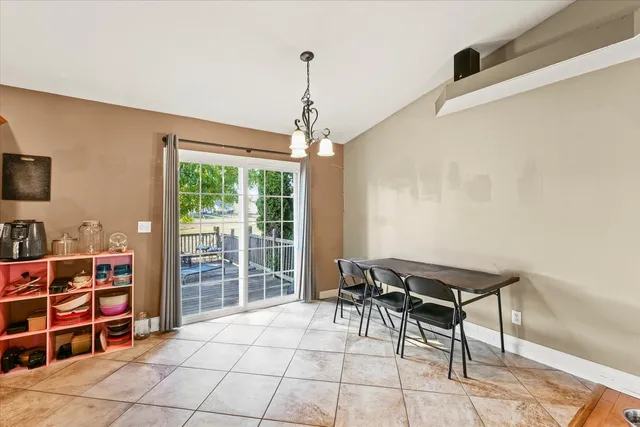 a living room with furniture a flat screen tv and a floor to ceiling window