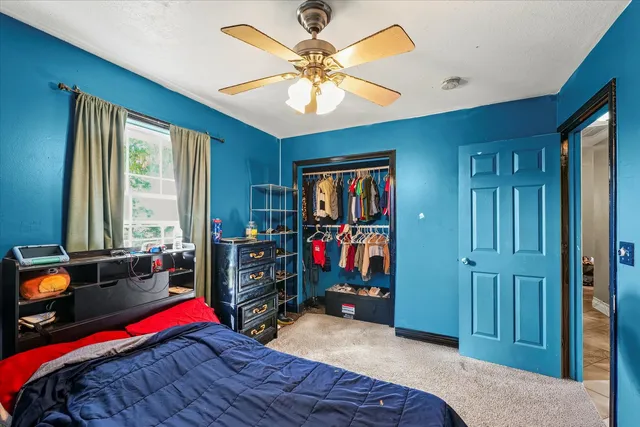 a bedroom with bed and a chandelier