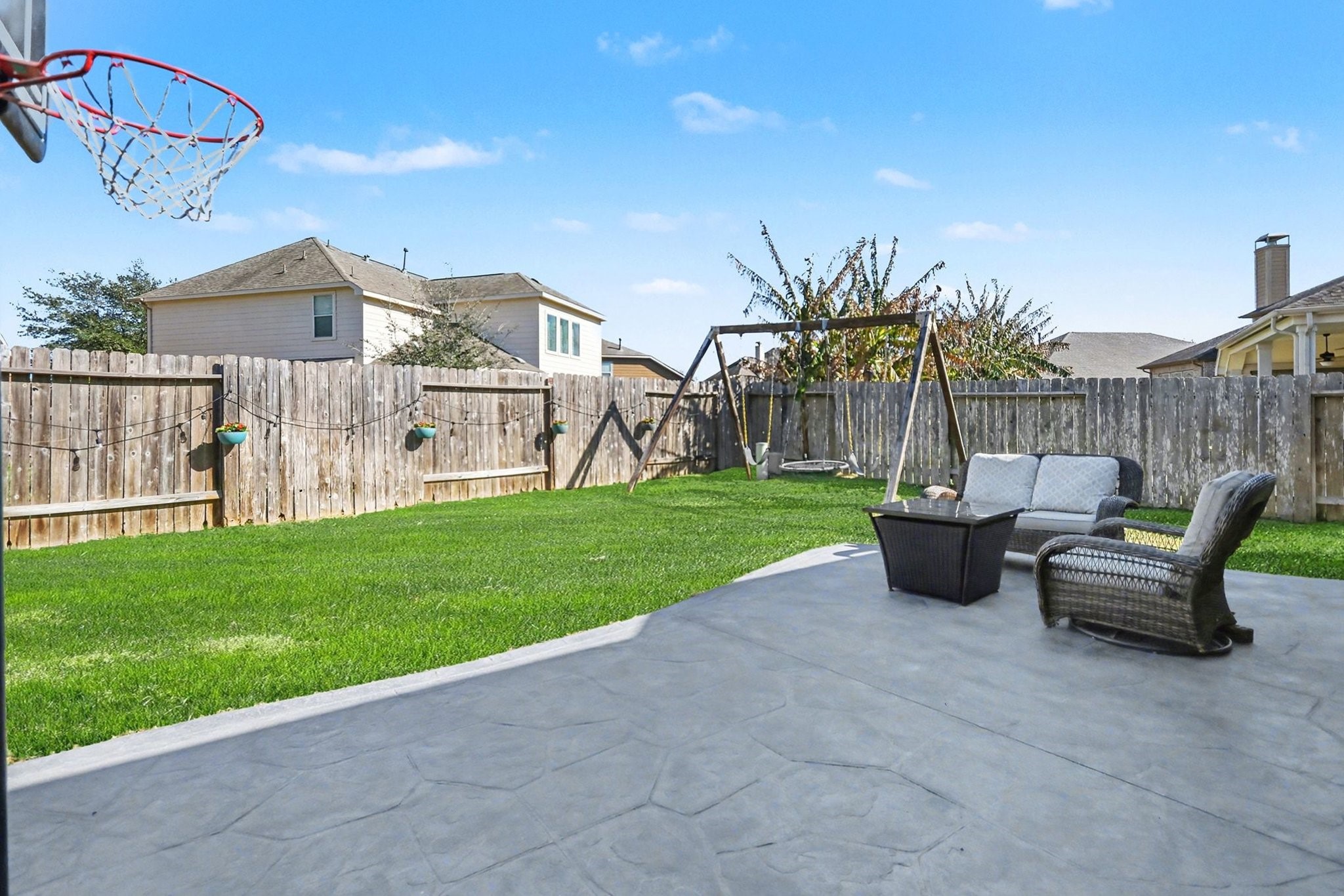 27006 Cliff Pointe Lane Katy, TX 77494 - Photo 31 of 34 Spacious backyard with extended concrete patio—ideal for outdoor dining, playtime, or relaxing evenings at home.