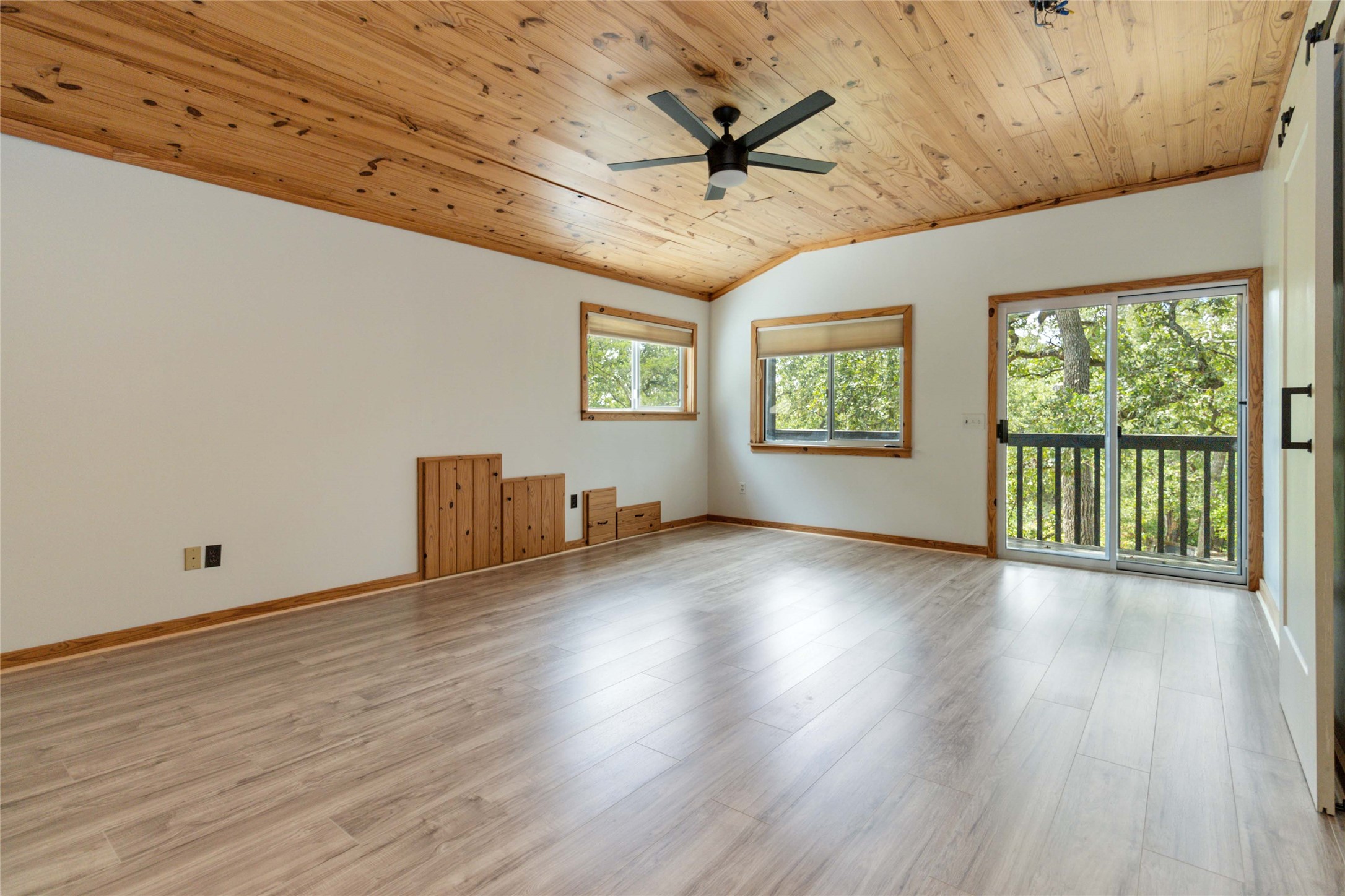 180 Ironstone Road Smithville, TX 78957 - Photo 14 of 37 Unfurnished room featuring a vaulted wooden ceiling, a ceiling fan, plenty of natural light, and light wood-type flooring
