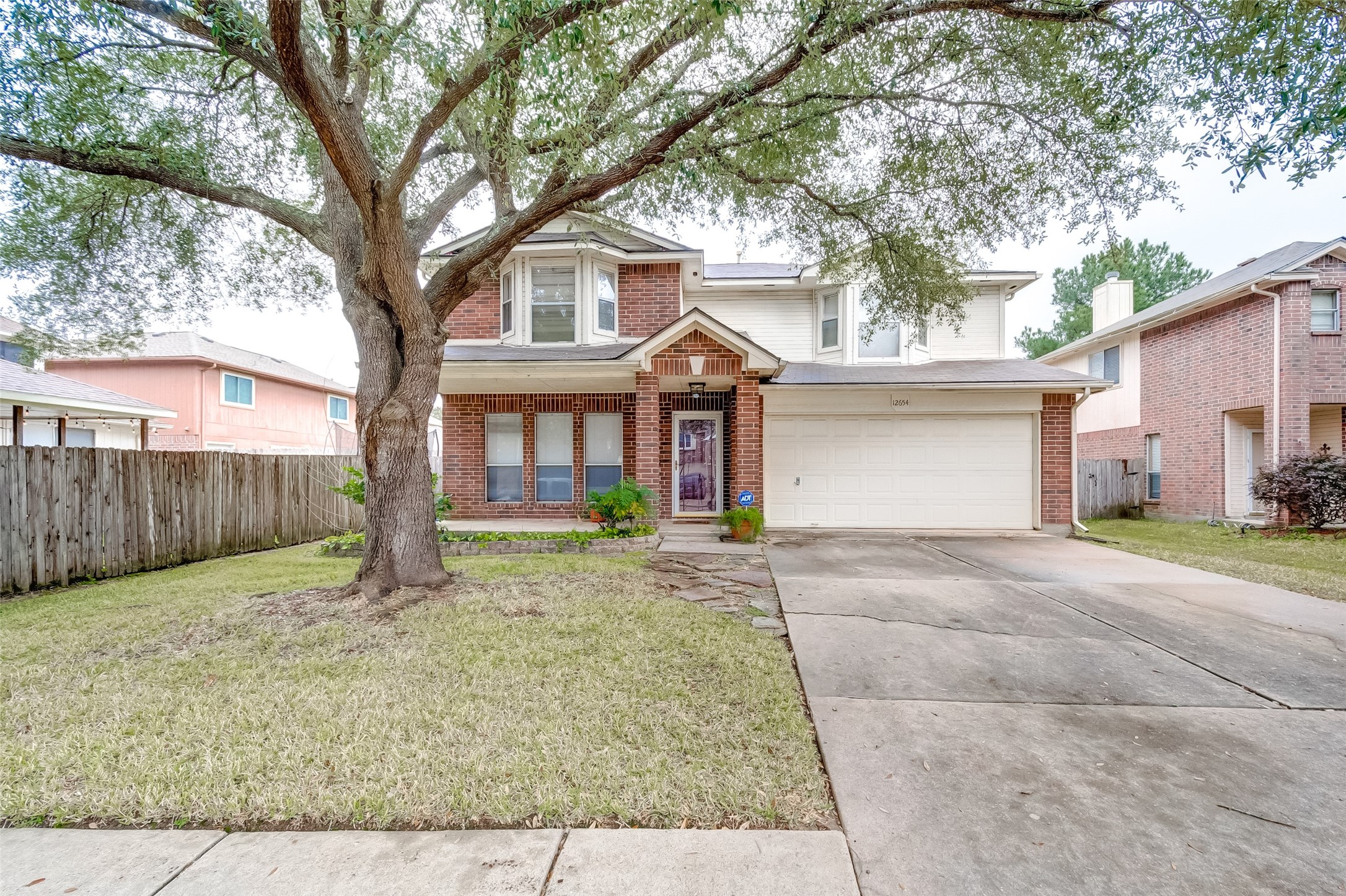 12654 Pine Bush Drive Houston, TX 77070 - Photo 1 of 35 a front view of a house with a yard and garage
