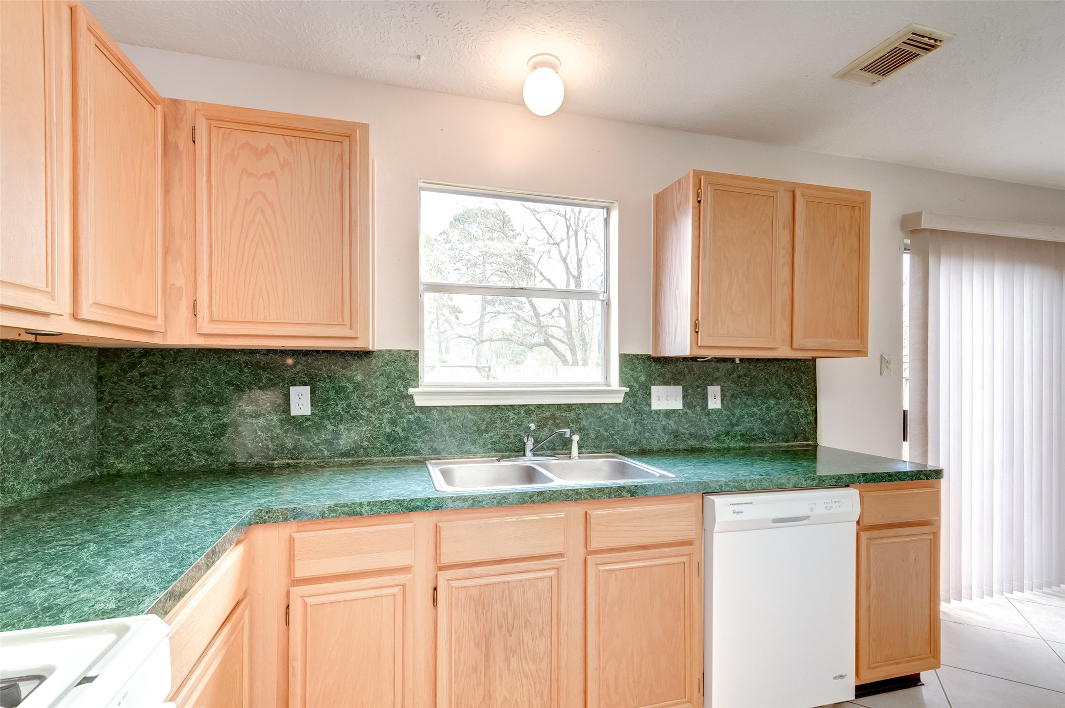 12654 Pine Bush Drive Houston, TX 77070 - Photo 11 of 35 a kitchen with a window a sink and a window