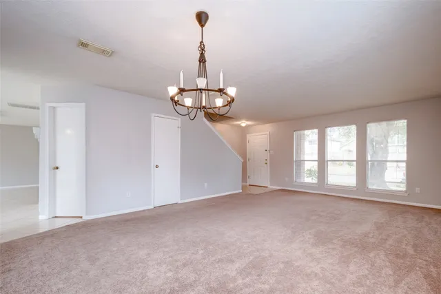 a view of a room with windows and chandelier