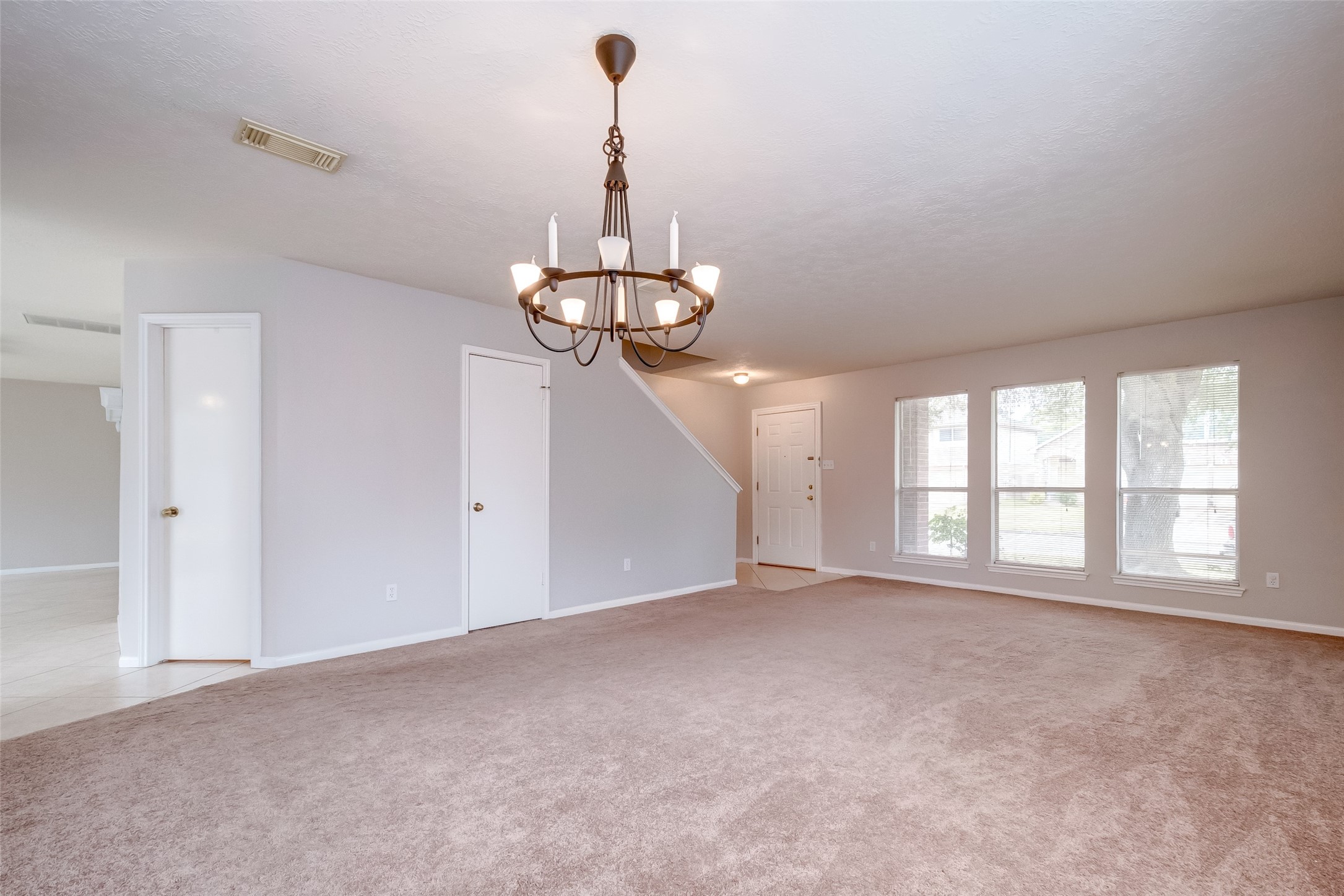 12654 Pine Bush Drive Houston, TX 77070 - Photo 18 of 35 a view of a room with windows and chandelier