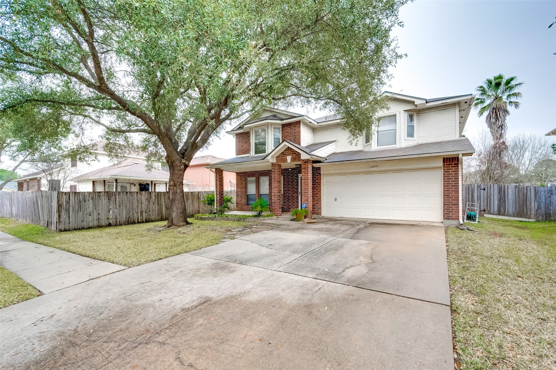 12654 Pine Bush Drive Houston, TX 77070 - Photo 2 of 35 a front view of a house with a yard and garage