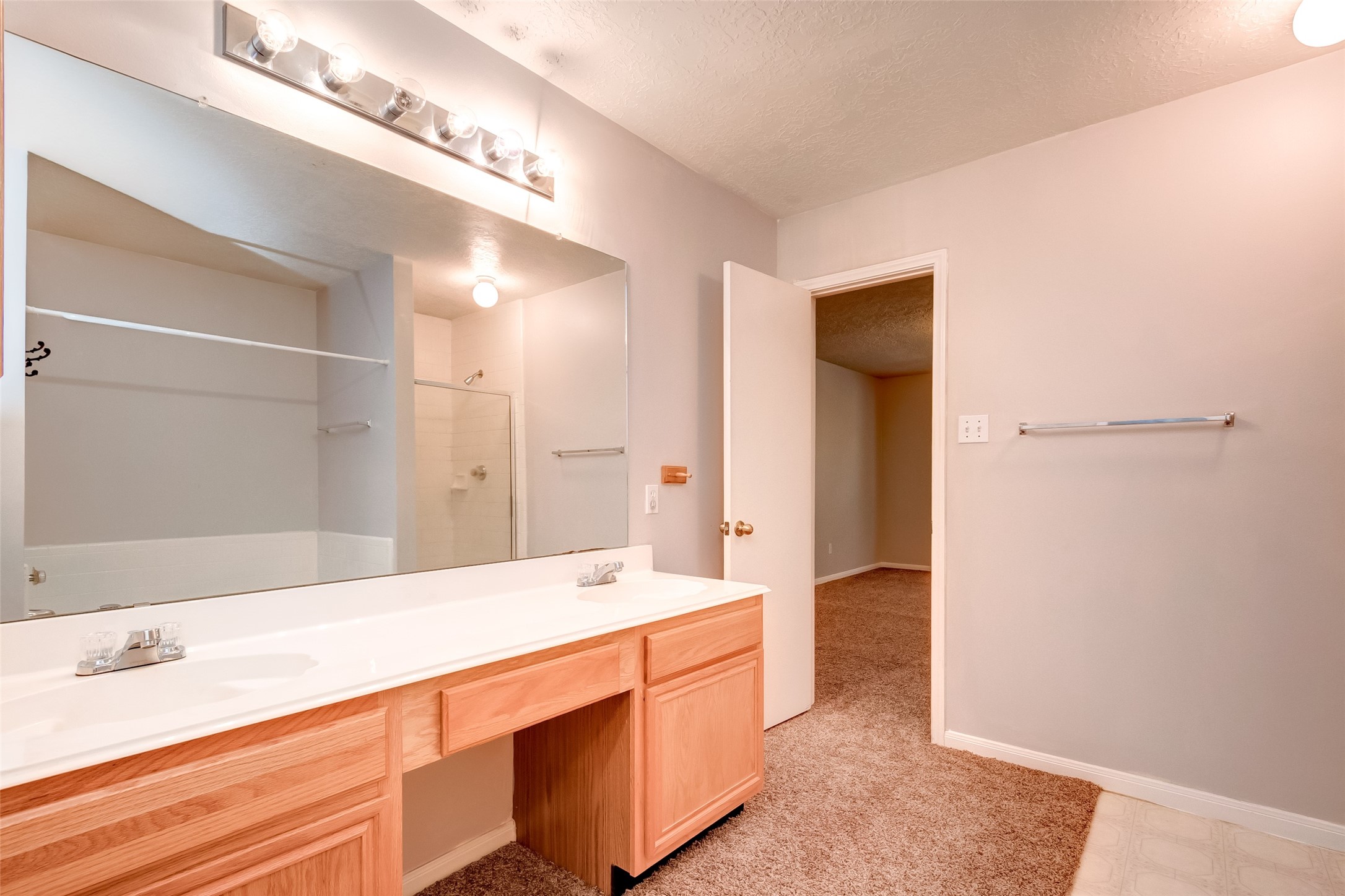 12654 Pine Bush Drive Houston, TX 77070 - Photo 30 of 35 a spacious bathroom with a double vanity sink and a large mirror