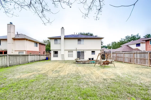 a view of a house with patio and a yard