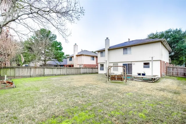 a backyard of a house with table and chairs
