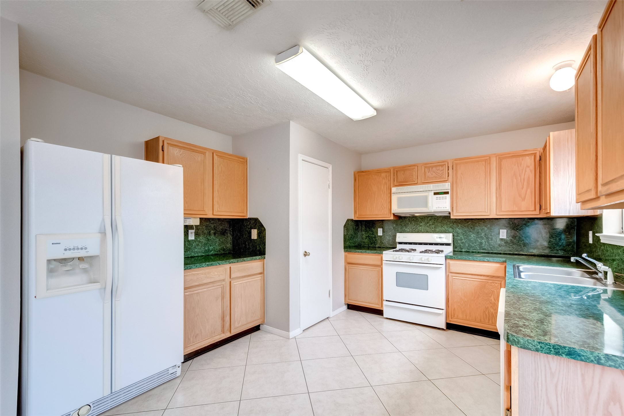 12654 Pine Bush Drive Houston, TX 77070 - Photo 9 of 35 a kitchen with stainless steel appliances a refrigerator sink and stove