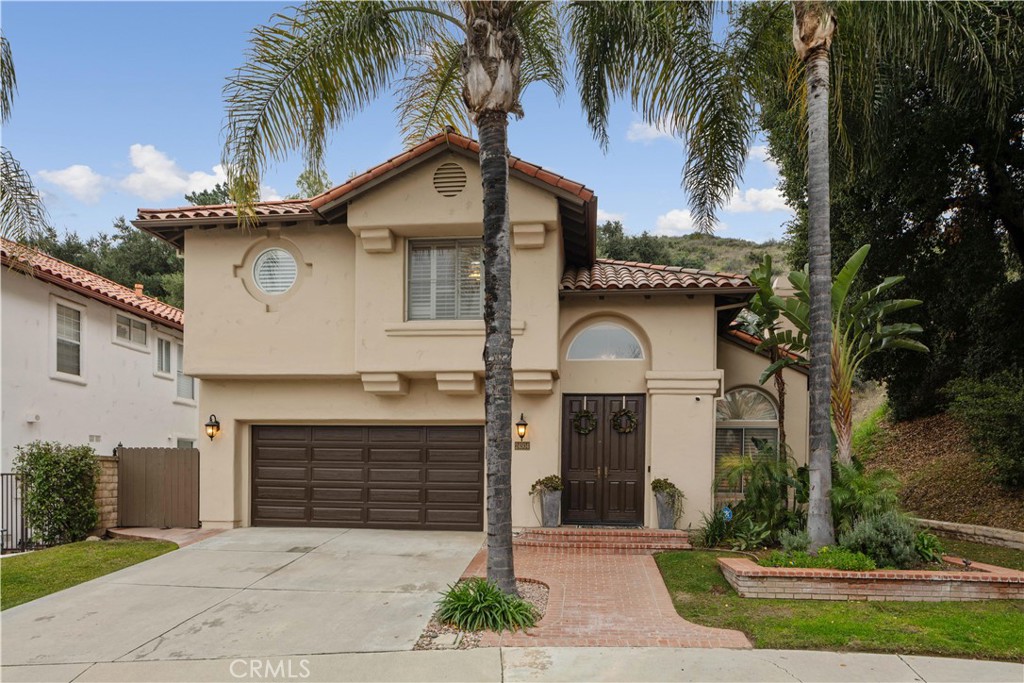 24504 Ebelden Avenue Newhall, CA 91321 - Photo 1 of 1 a front view of a house with a yard and garage