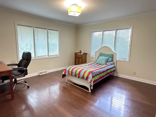 a bedroom with a bed a desk and chair