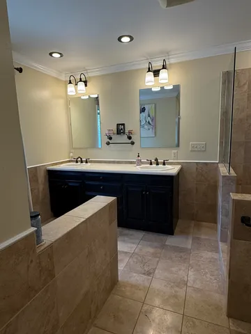 a bathroom with a sink vanity and mirror