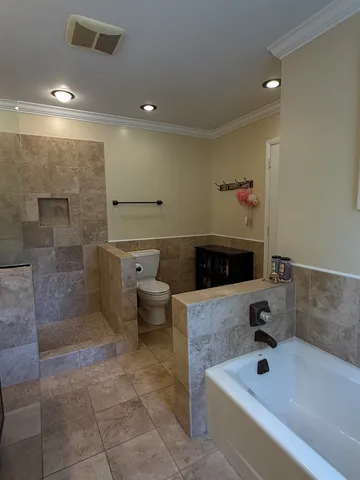 a bathroom with a bathtub and shower