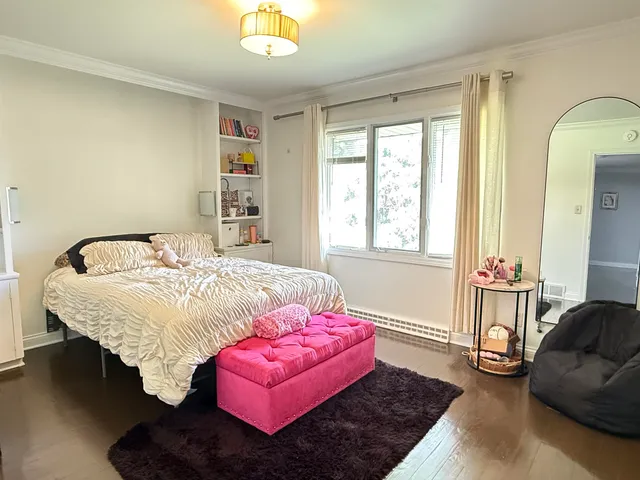 a bedroom with a bed couch and window