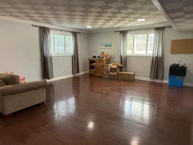 a living room with furniture window and wooden floor