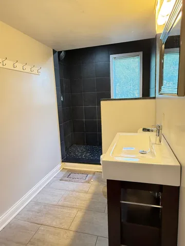 a bathroom with a sink a toilet and mirror