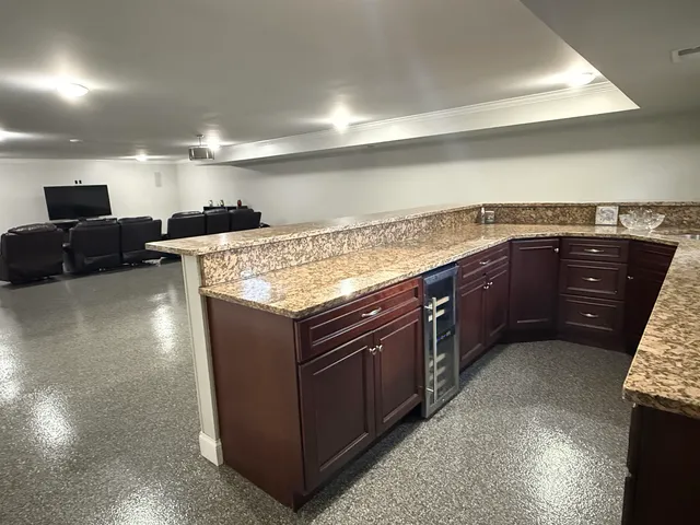 a kitchen with stainless steel appliances granite countertop a sink counter space and wooden floor
