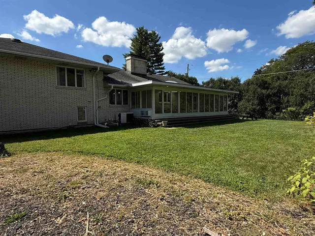 a view of a house with yard and a garden