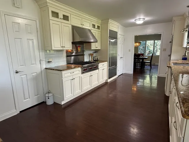 a kitchen with stainless steel appliances a sink stove and cabinets