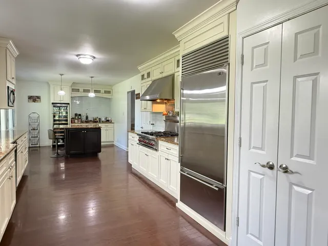 a kitchen with a refrigerator and a sink