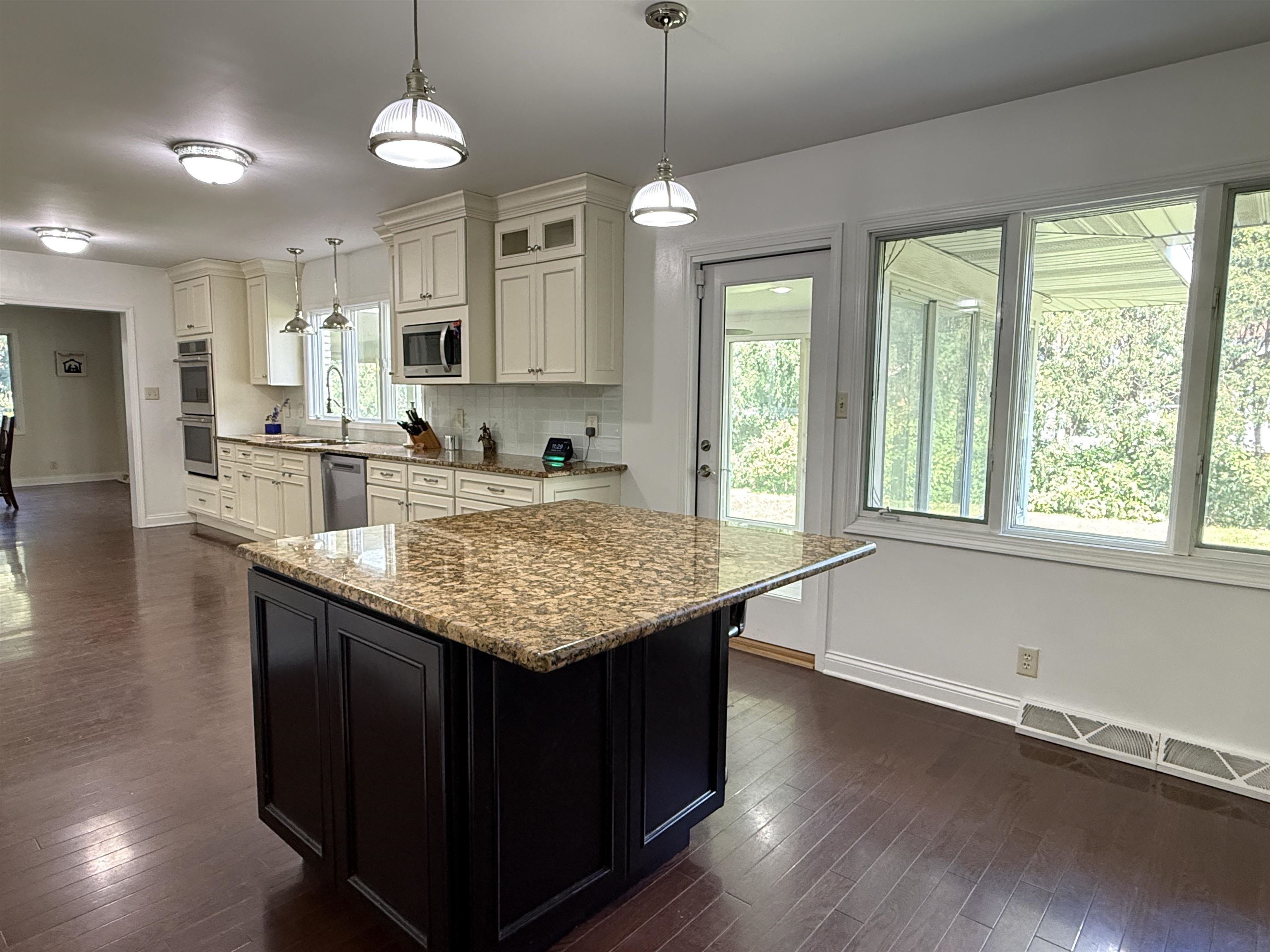 402 West Le Fevre Road Sterling, IL 61081 - Photo 9 of 39 a kitchen with center island wooden floor center island and stainless steel appliances