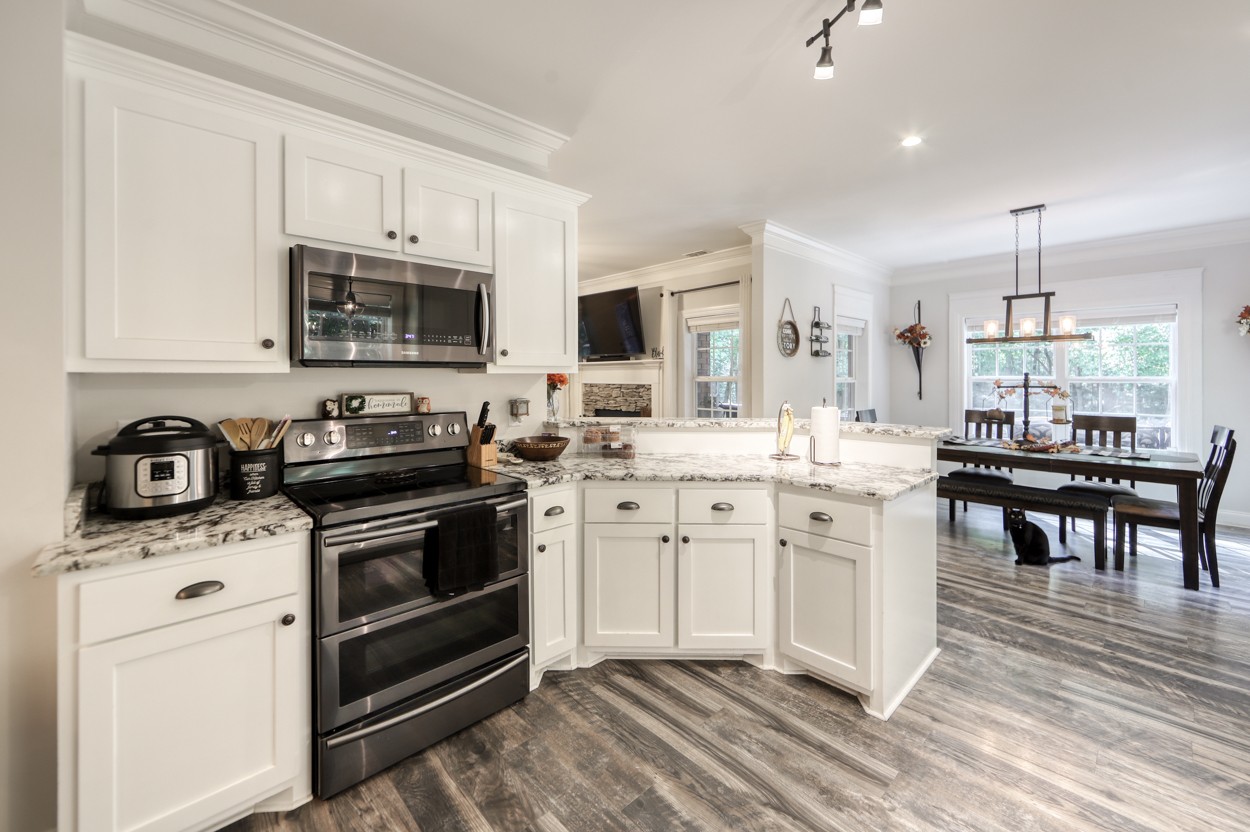65 Sheltontown Road Manchester, TN 37355 - Photo 12 of 46 a kitchen with stainless steel appliances granite countertop a stove top oven a sink a microwave and a refrigerator
