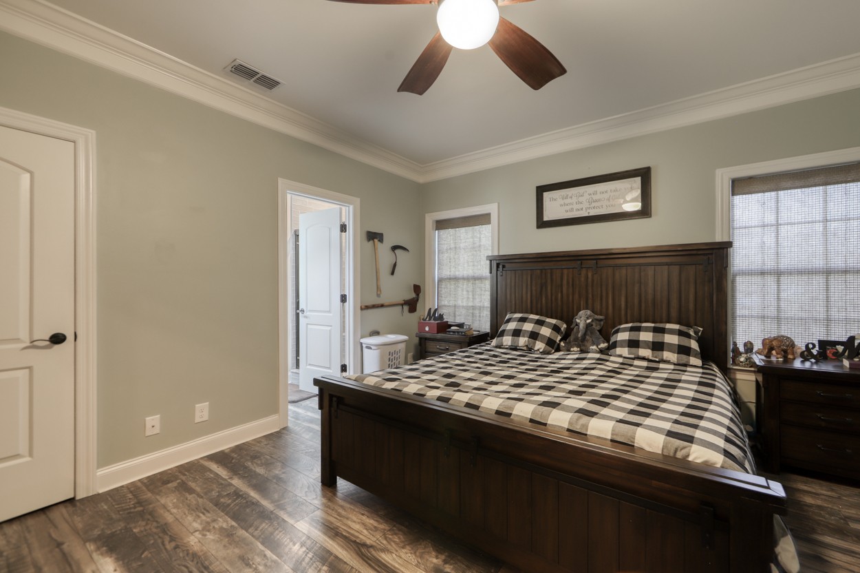 65 Sheltontown Road Manchester, TN 37355 - Photo 17 of 46 a bedroom with a large bed and a chandelier