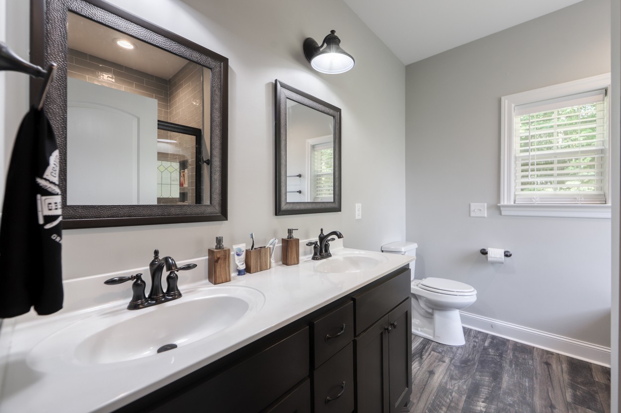 65 Sheltontown Road Manchester, TN 37355 - Photo 18 of 46 a bathroom with a double vanity sink and a mirror
