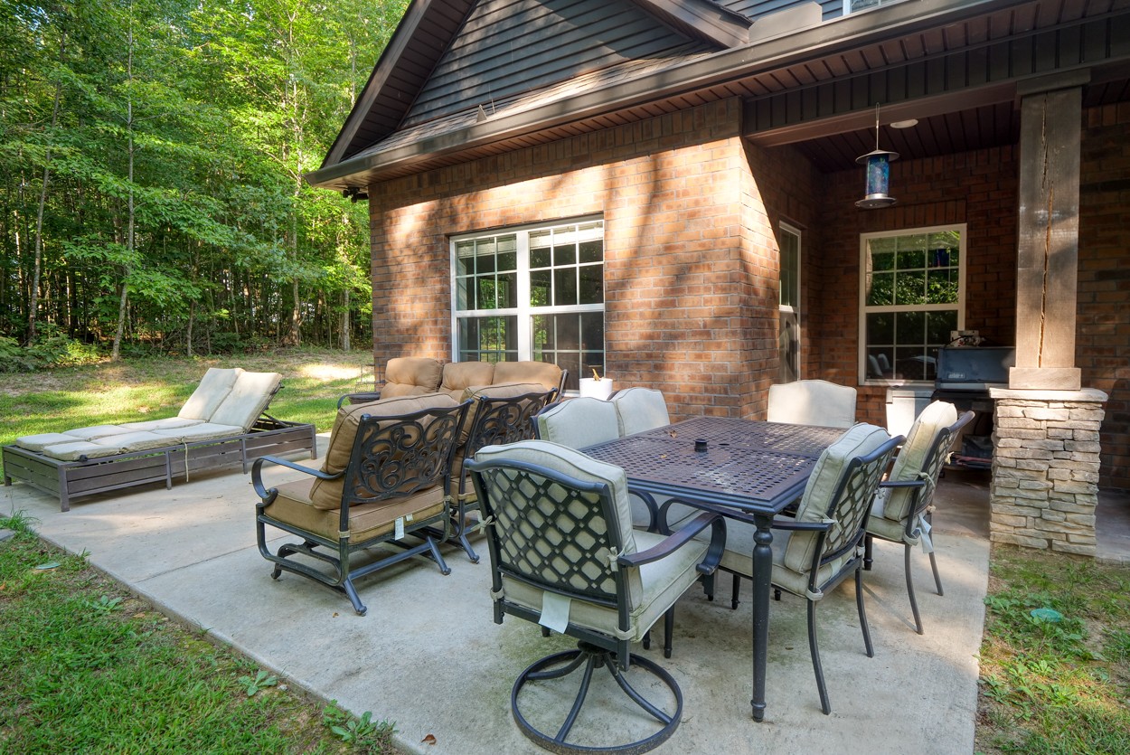 65 Sheltontown Road Manchester, TN 37355 - Photo 39 of 46 a view of a patio with a dining table and chairs
