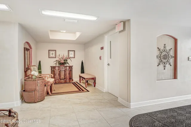 a view of a workspace with furniture and a gate