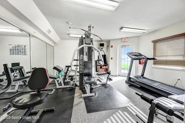 a room with furniture pool table and window