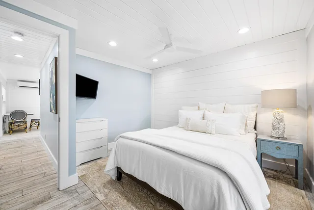 a bedroom with a bed and a flat screen tv