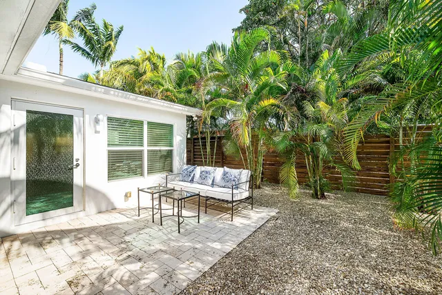 a house view with a sitting space and garden