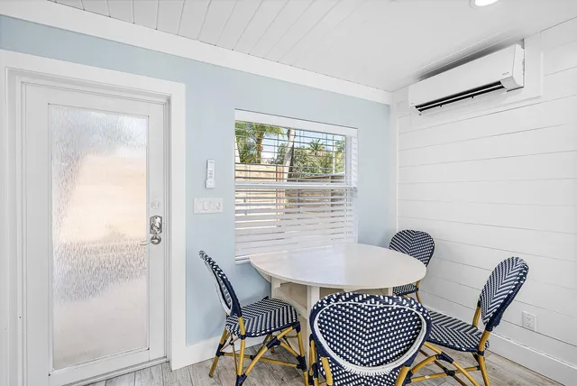 a view of a room with furniture and wooden floor