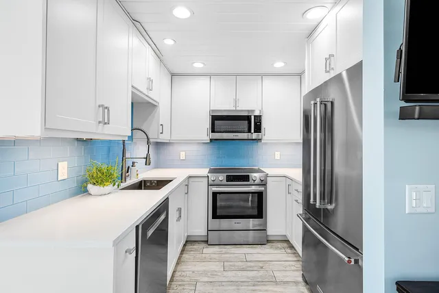 a kitchen with a sink stainless steel appliances and cabinets