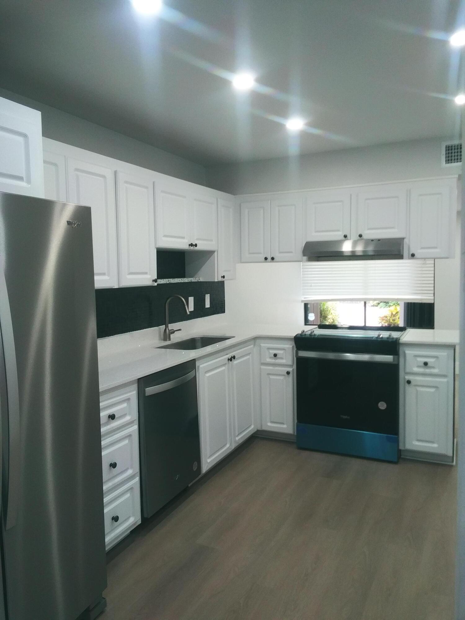 9727 North New River Canal Road, Unit 629 Plantation, FL 33324 - Photo 11 of 28 a kitchen with stainless steel appliances granite countertop a refrigerator stove and sink
