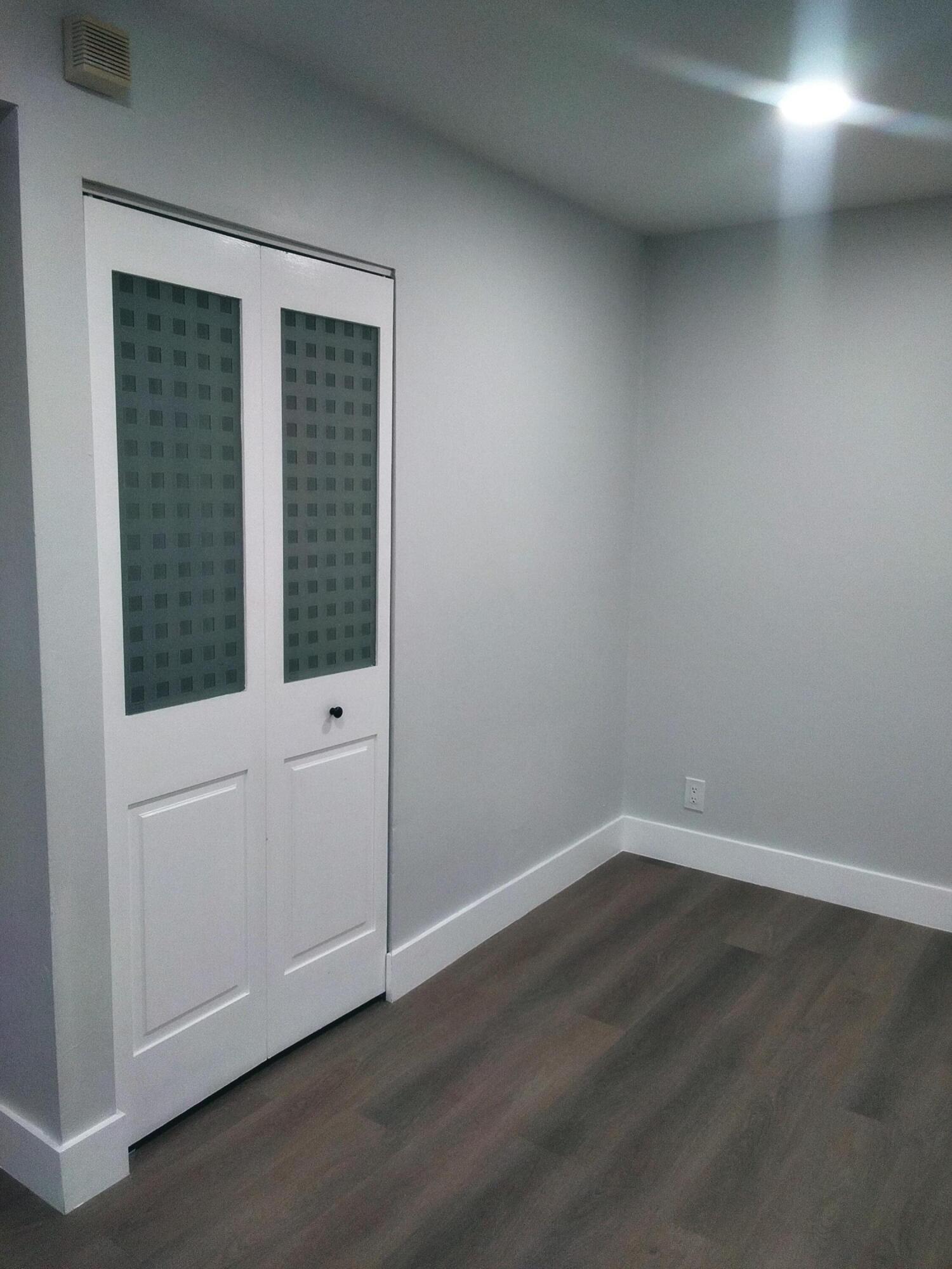 9727 North New River Canal Road, Unit 629 Plantation, FL 33324 - Photo 5 of 28 an empty room with wooden floor and windows