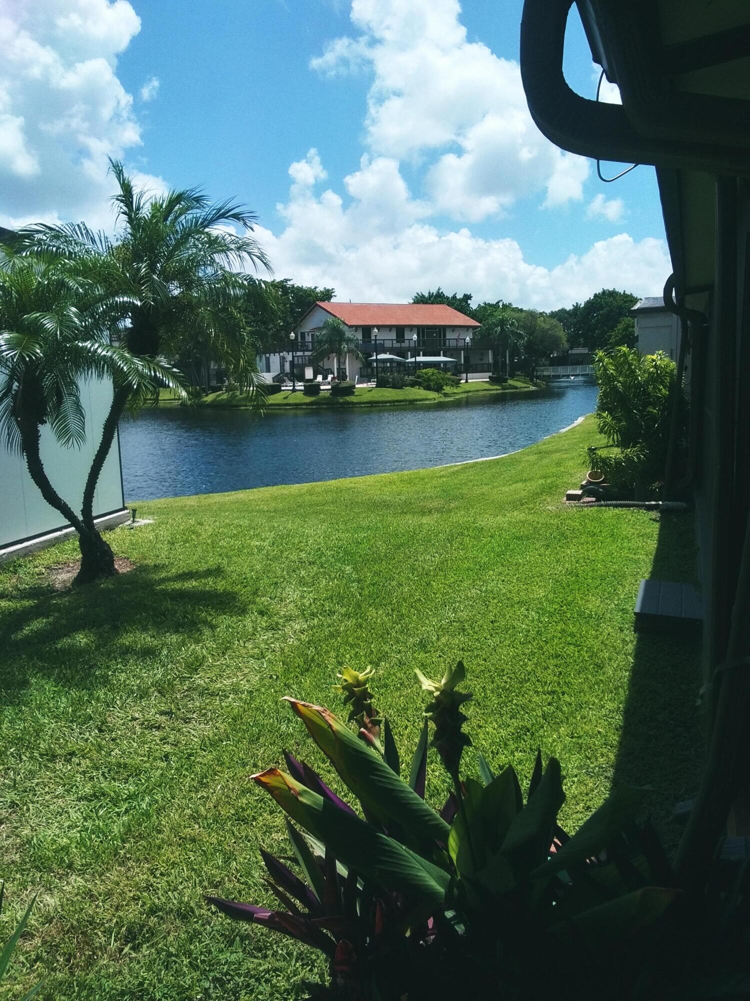 9727 North New River Canal Road, Unit 629 Plantation, FL 33324 - Photo 9 of 28 a view of a lake with a big yard