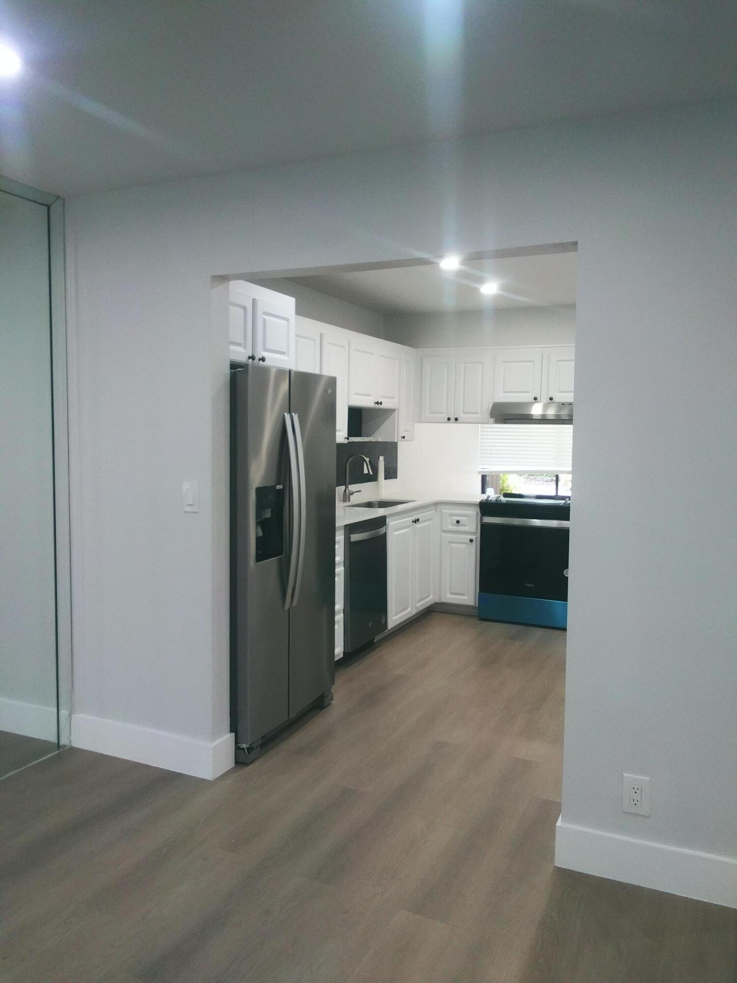 9727 North New River Canal Road, Unit 629 Plantation, FL 33324 - Photo 10 of 28 a kitchen with stainless steel appliances granite countertop a refrigerator a stove and a sink