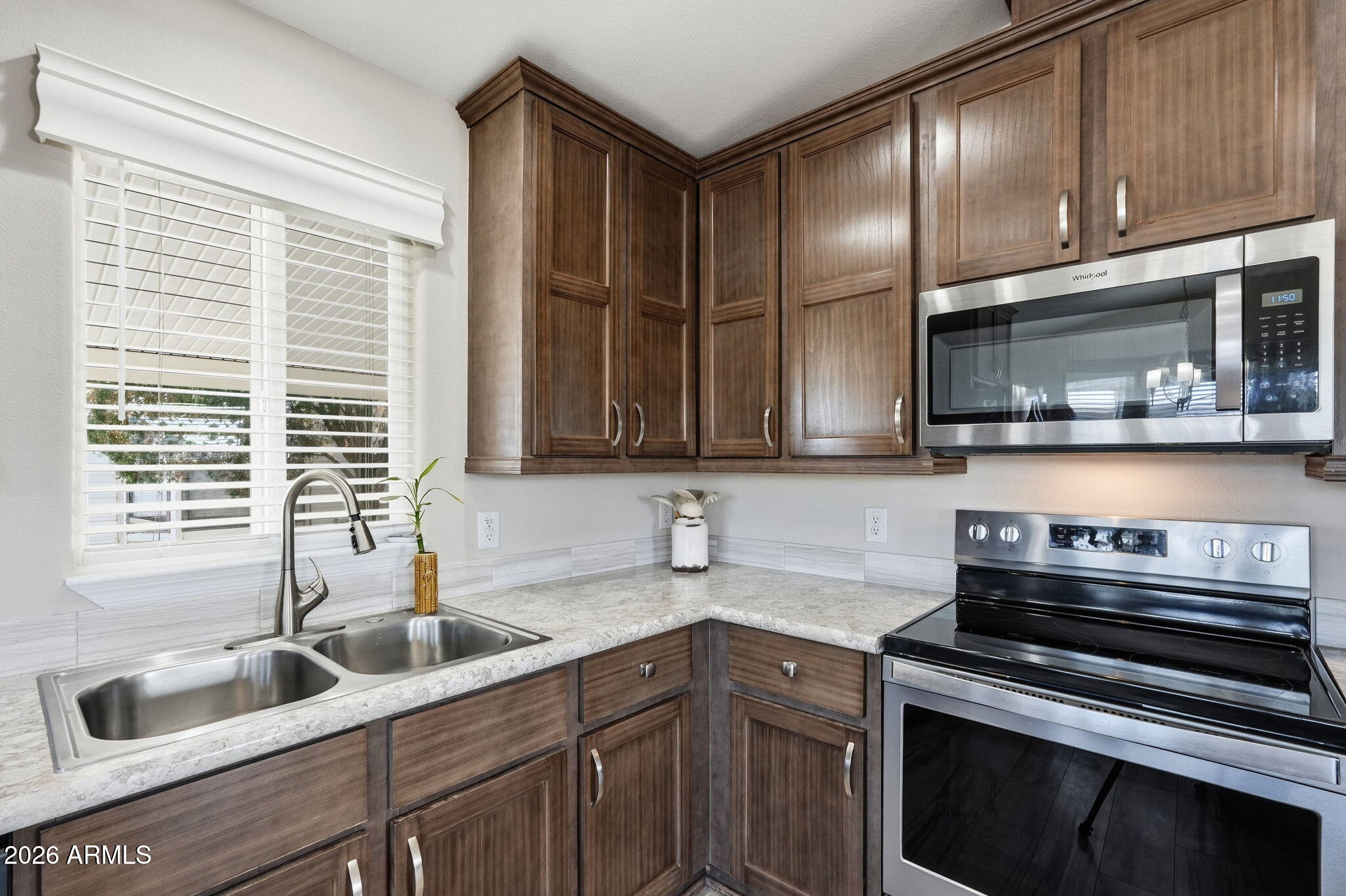 8865 East Baseline Road, Unit 1417 Mesa, AZ 85209 - Photo 16 of 47 a kitchen with stainless steel appliances granite countertop a sink stove and cabinets