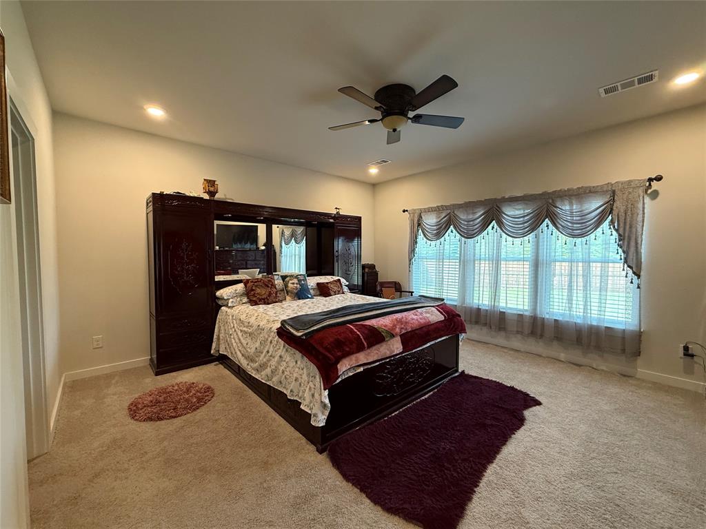 785 Vineyard Way Forney, TX 75126 - Photo 8 of 12 Carpeted room featuring a ceiling fan with integrated lighting, recessed lighting, and a large window with blinds and valance